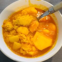 A picture of White beans with rice, chicken, potatoes and chorizo.