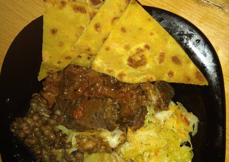 Pumpkin chappati served with beef, lentil stew and steamed cabbage