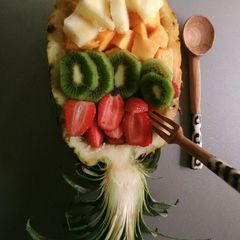 A picture of Fruit salad in a pineapple boat.