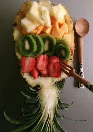 A picture of Fruit salad in a pineapple boat.