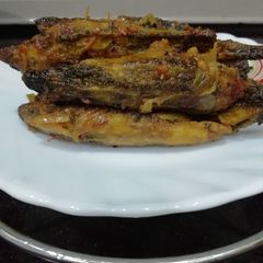 A picture of Stuffed Bitter Gourd with peel and fried onion stuffing.
