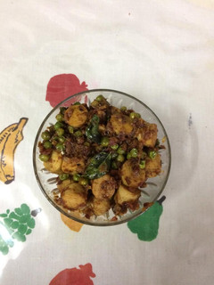 A picture of Chicken sausages with green peas.