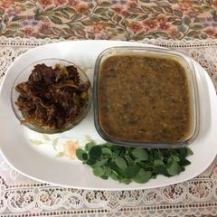 A picture of Green gram dal with drumsticks leavesAnd bitter gourd pickle.