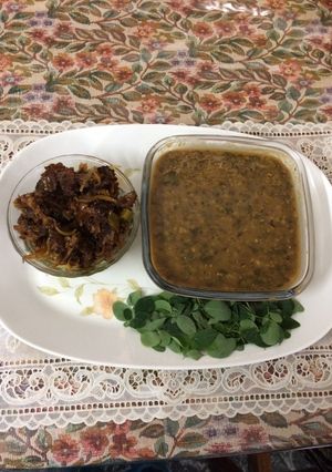 A picture of Green gram dal with drumsticks leavesAnd bitter gourd pickle.