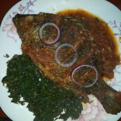 A picture of Fried fish,ugali with greens(kunde,managu,terere and spinach).