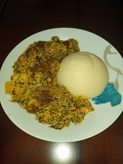 A picture of Egusi soup and Semivita.