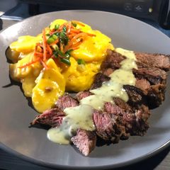 A picture of Seared Strip w/ Creamy Cilantro Lime Sauce & Scalloped Potatoes.