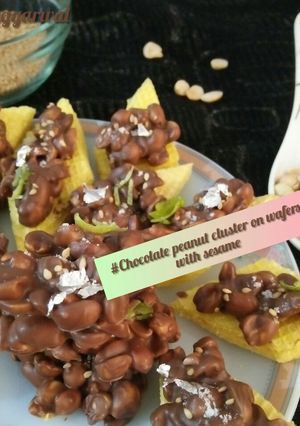 A picture of Chocolate peanut cluster on wafers with sesame.