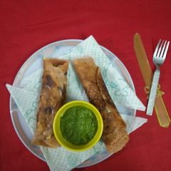 A picture of Quick dosa wrapped in naughty potatoes and cheese.