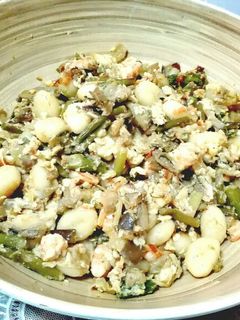 Una foto de Huevos revueltos con ñoquis verduras, gambas y queso fresco
