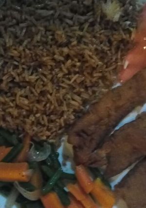 A picture of Fish fillets served together with pilau.