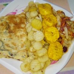 A picture of Chips, plantain and fried egg with sauce.