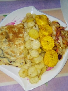 A picture of Chips, plantain and fried egg with sauce.