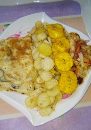 A picture of Chips, plantain and fried egg with sauce.