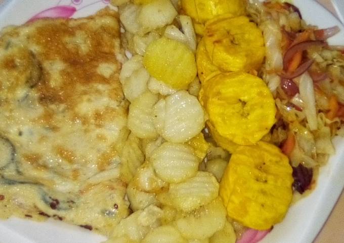 Chips, plantain and fried egg with sauce