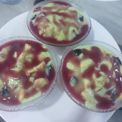 A picture of Pista fruit custard orange jelly with black currant sauce.