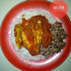 A picture of Rice and beans with chicken stew.