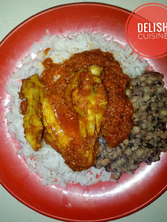 A picture of Rice and beans with chicken stew.