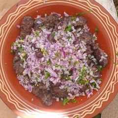 A picture of Moroccan Grilled Kefta with Fresh Onion & Parsley.