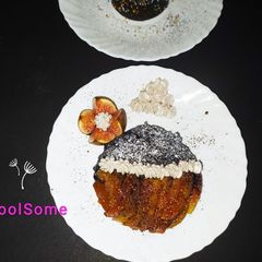 A picture of Decadent chocolate cake with cheesy waffer and caramelized fig.