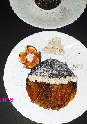 A picture of Decadent chocolate cake with cheesy waffer and caramelized fig.