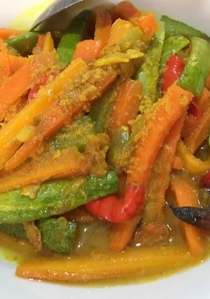 A picture of Cucumber and Carrot Pickle with Yellow Spices.