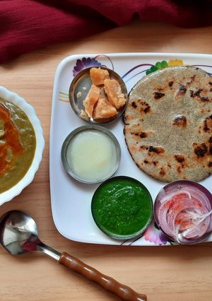 A picture of Bajra Roti with saag/Jaggery/chutney.