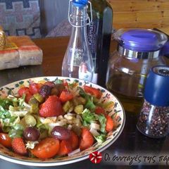 A picture of Green salad with parmezan and strawberries.