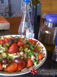 A picture of Green salad with parmezan and strawberries.