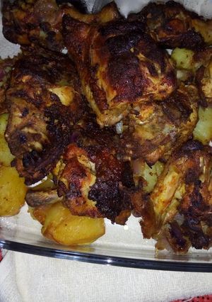 A picture of Baked chicken in veggies.