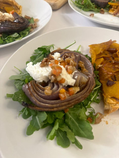 A picture of Roasted Onion and Arugula Salad with Walnut Salsa.