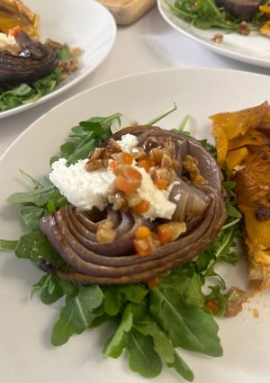 A picture of Roasted Onion and Arugula Salad with Walnut Salsa.