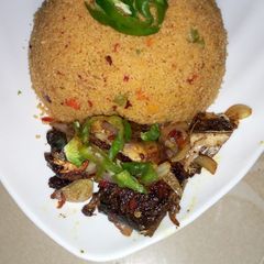 A picture of Jollof couscous with pepper fish.