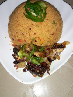 A picture of Jollof couscous with pepper fish.