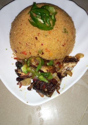 A picture of Jollof couscous with pepper fish.