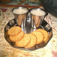 A picture of Jaggery milk with biscuits.