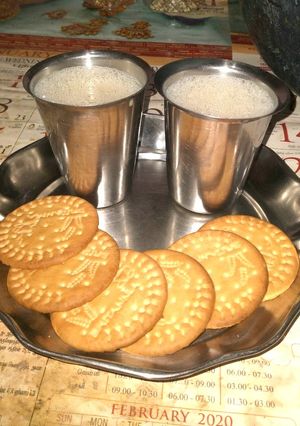 A picture of Jaggery milk with biscuits.