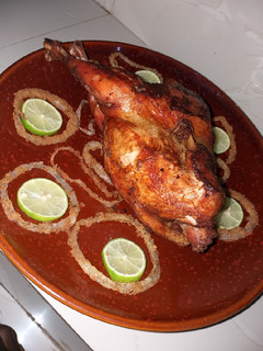 A picture of Stuffed chicken with macaroni and onion rings.