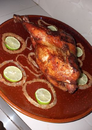 A picture of Stuffed chicken with macaroni and onion rings.