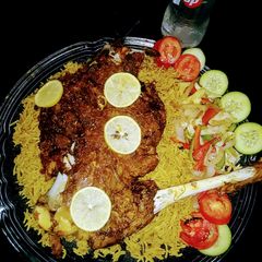 A picture of Mutton leg steam roast with special rice and veggies.