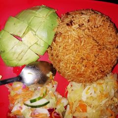 Pilau served with cabbage and salad A picture of Pilau served with cabbage and salad.