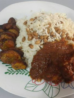 A picture of Rice and beans with fried plantain.