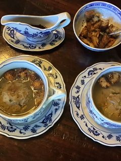 A picture of California Farm Chicken Liver Dumpling Matzo Soup with Croutons.