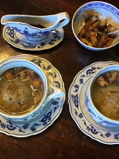 A picture of California Farm Chicken Liver Dumpling Matzo Soup with Croutons.
