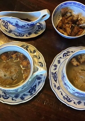 A picture of California Farm Chicken Liver Dumpling Matzo Soup with Croutons.