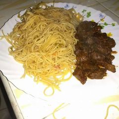 A picture of Fried liver and spaghetti.