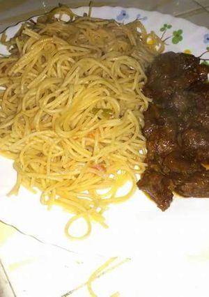 A picture of Fried liver and spaghetti.