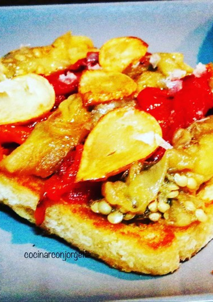 Una foto de Pan de molde templado con escalivada y ajos fritos