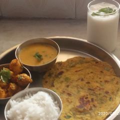 A picture of Mini thali - arvi sabji,dal fry, methi thepla,rice & buttermilk.