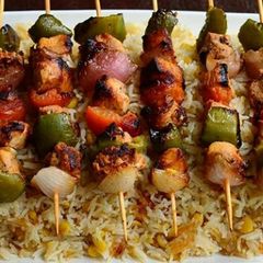 A picture of Chicken tikka sticks with chana daal garlic rice.